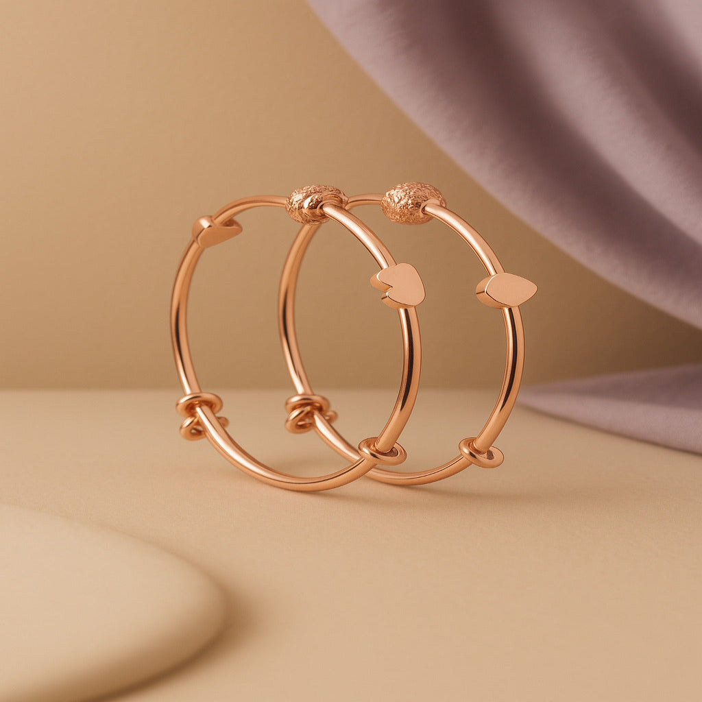 Rose gold hoop earrings on a beige background