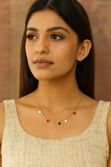 Woman wearing a delicate necklace with a neutral background