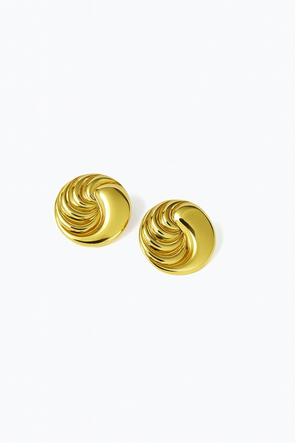 Pair of gold spiral earrings on a white background
