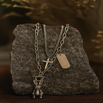 Necklace with various pendants on a textured stone surface