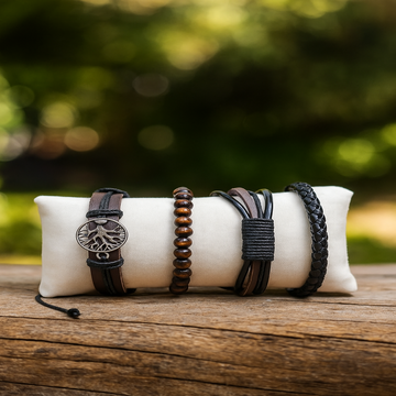 Set of bracelets on a white cushion with a blurred natural background