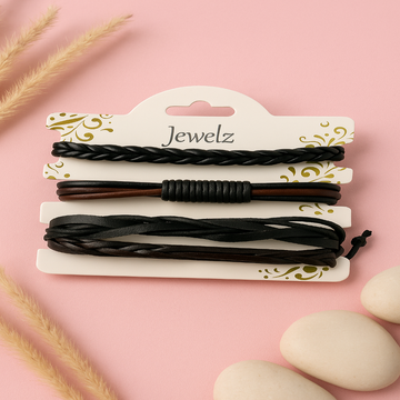 Set of black hair ties on a 'Jewelz' branded card against a pink background