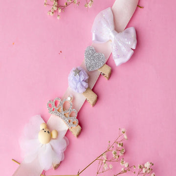 Decorative headbands with flowers and ribbons on a pink background