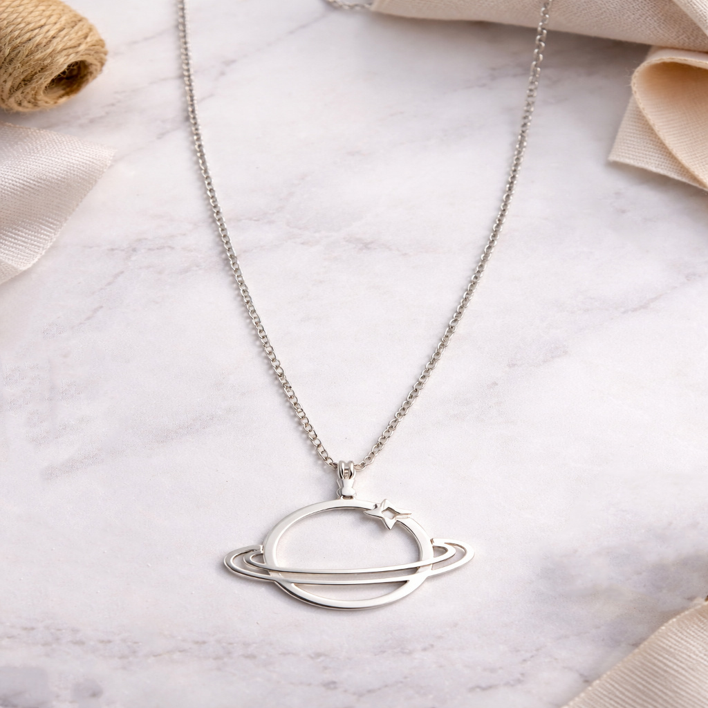 Silver necklace with a circular pendant on a marble surface