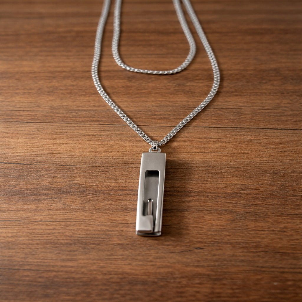 Silver necklace with a pendant on a wooden surface