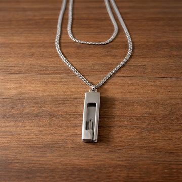 Silver necklace with a pendant on a wooden surface