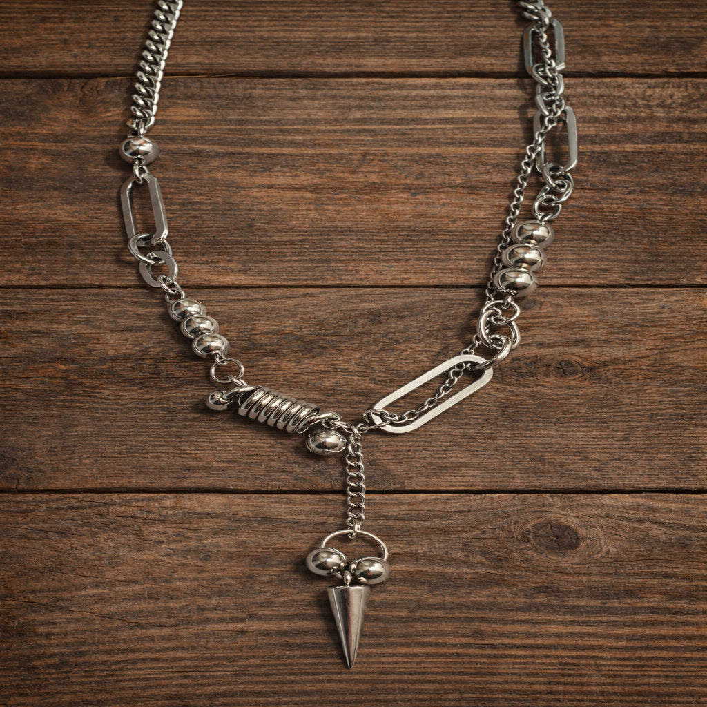 Silver chain necklace with a pendant on a wooden surface