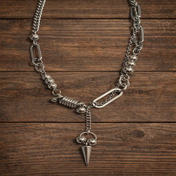 Silver chain necklace with a pendant on a wooden surface