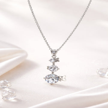 Silver necklace with a clear gemstone pendant on a white background