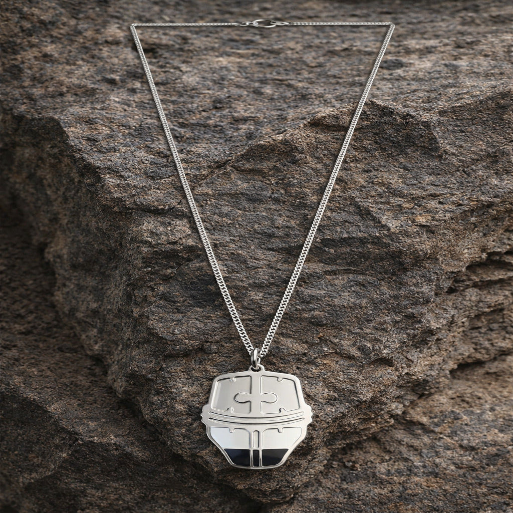Silver necklace with a pendant on a textured stone surface