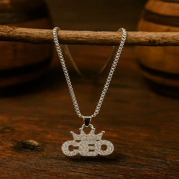 Silver necklace with 'CEO' pendant on a wooden surface
