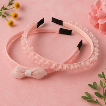 Pink headband with lace details and a bow on a pink background with flowers and leaves.