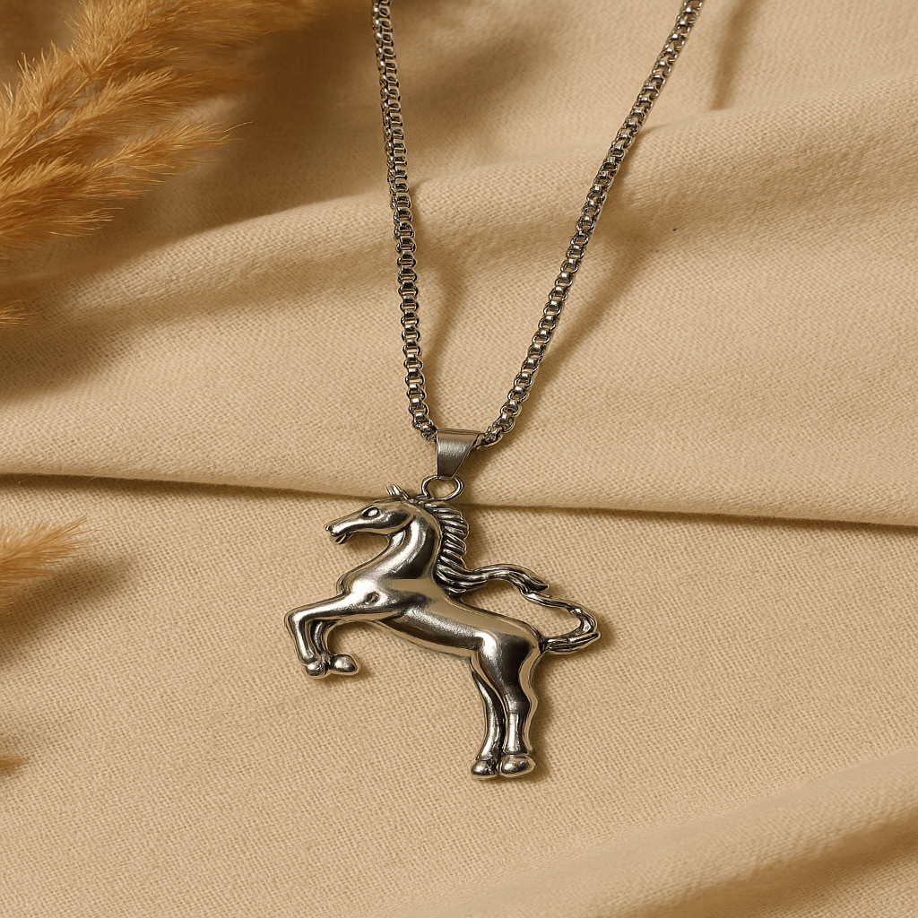 Silver horse pendant necklace on a beige fabric background