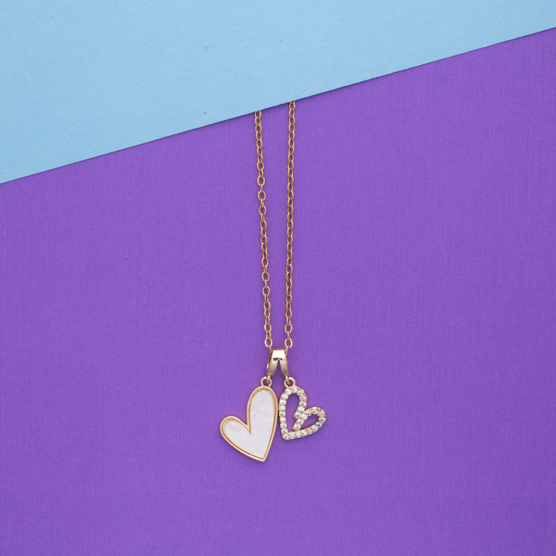Necklace with heart pendants on a purple and blue background