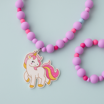 Necklace with pink and purple beads and a unicorn charm on a light blue background